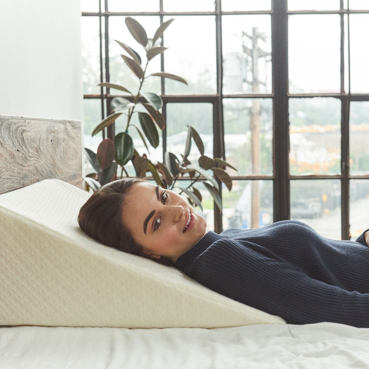 Brentwood Home Zuma foam wedge pillow in use on a bed