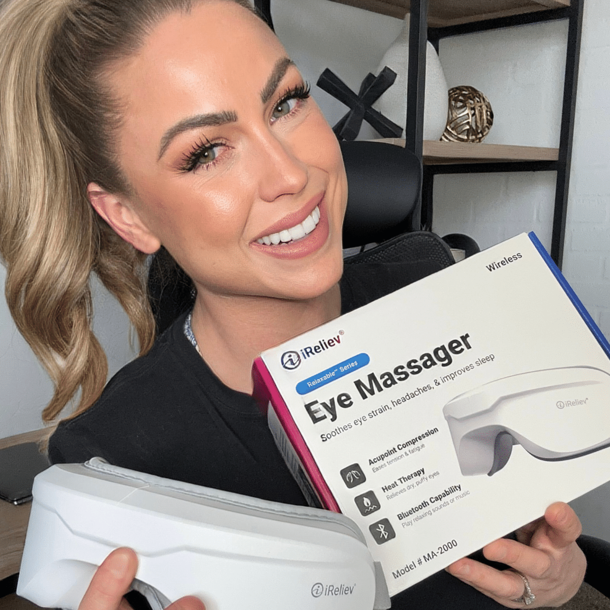 iReliev heated eye massager resting beside its matching neck pillow — view 4