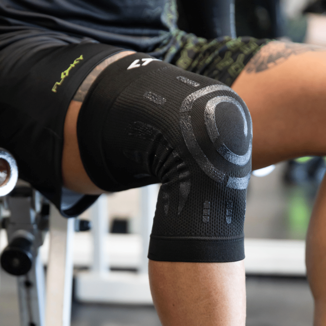Black Floky compression knee brace in size L-XL for the right knee, shown flat with silicone support bands — view 2