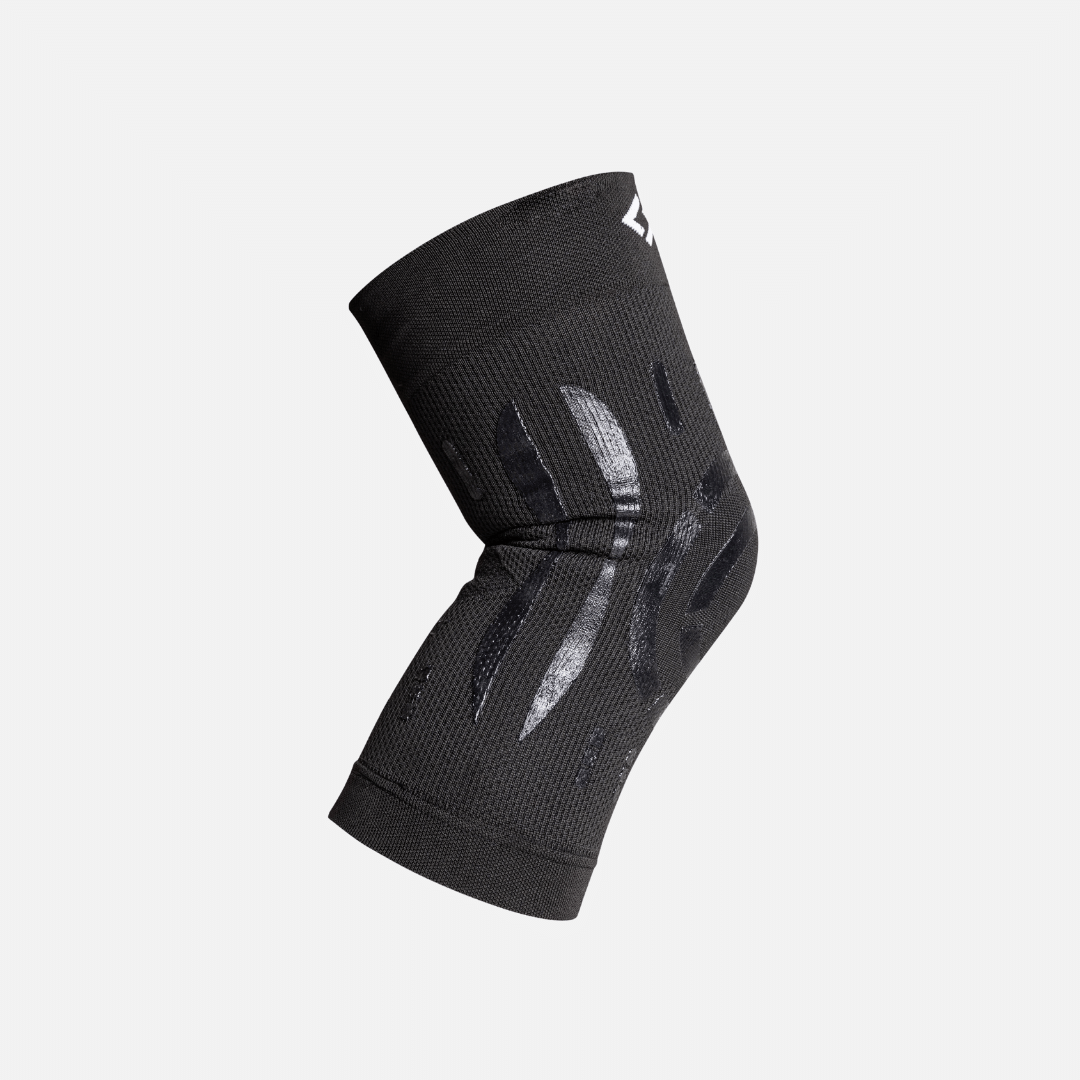 Black Floky compression knee brace in size L-XL for the right knee, shown flat with silicone support bands — view 4