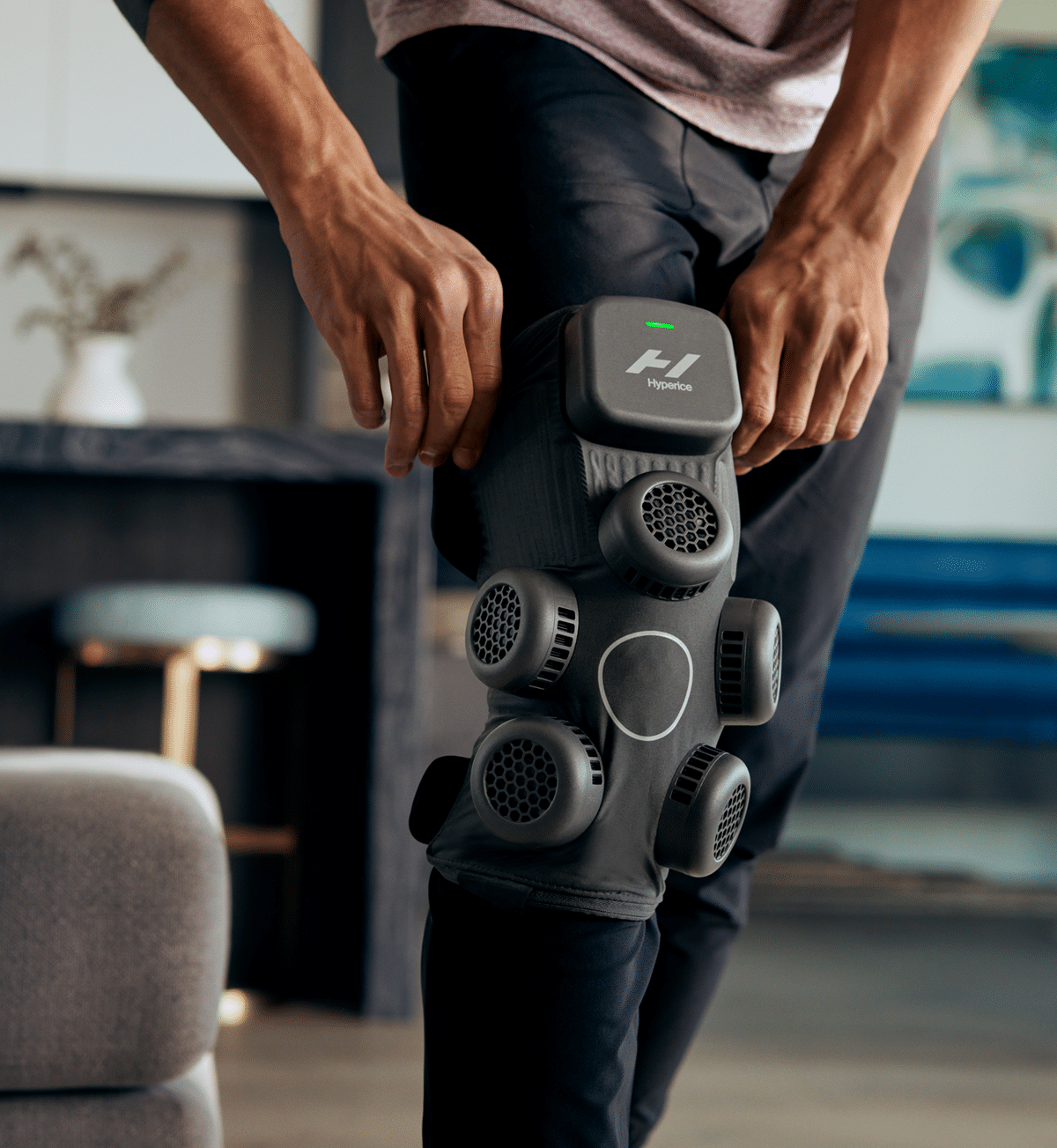 Hyperice X contrast therapy knee wrap fitted around a bent knee — view 2