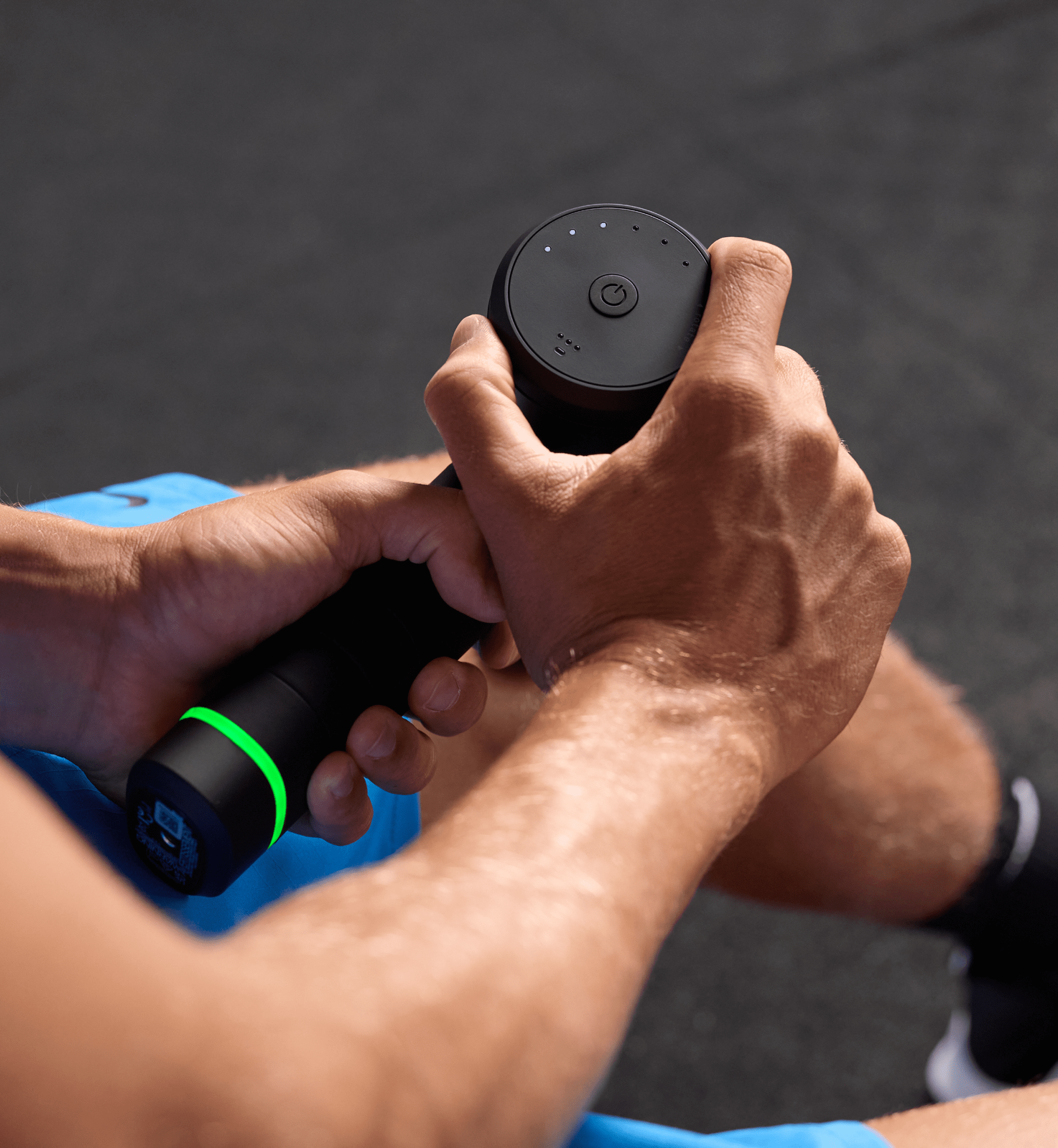 Hand turning the speed dial on the Hypervolt 3 Pro