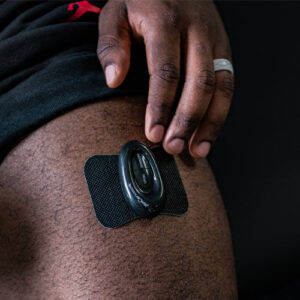 PlayMakar WiTENS Mini wireless TENS unit, a small white wearable pad with control buttons