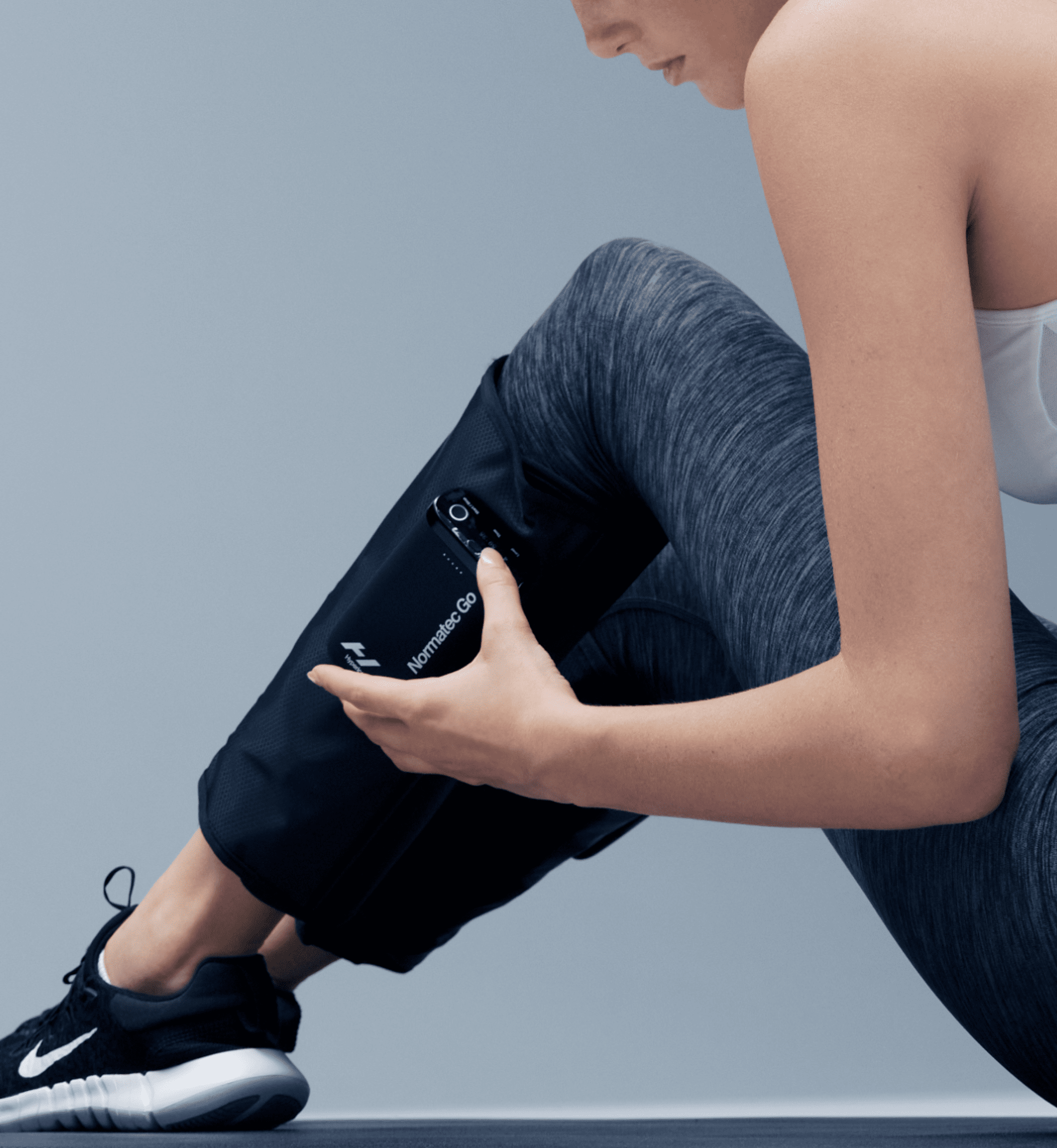 Hyperice Normatec Go portable calf compression wraps worn on both calves — view 4