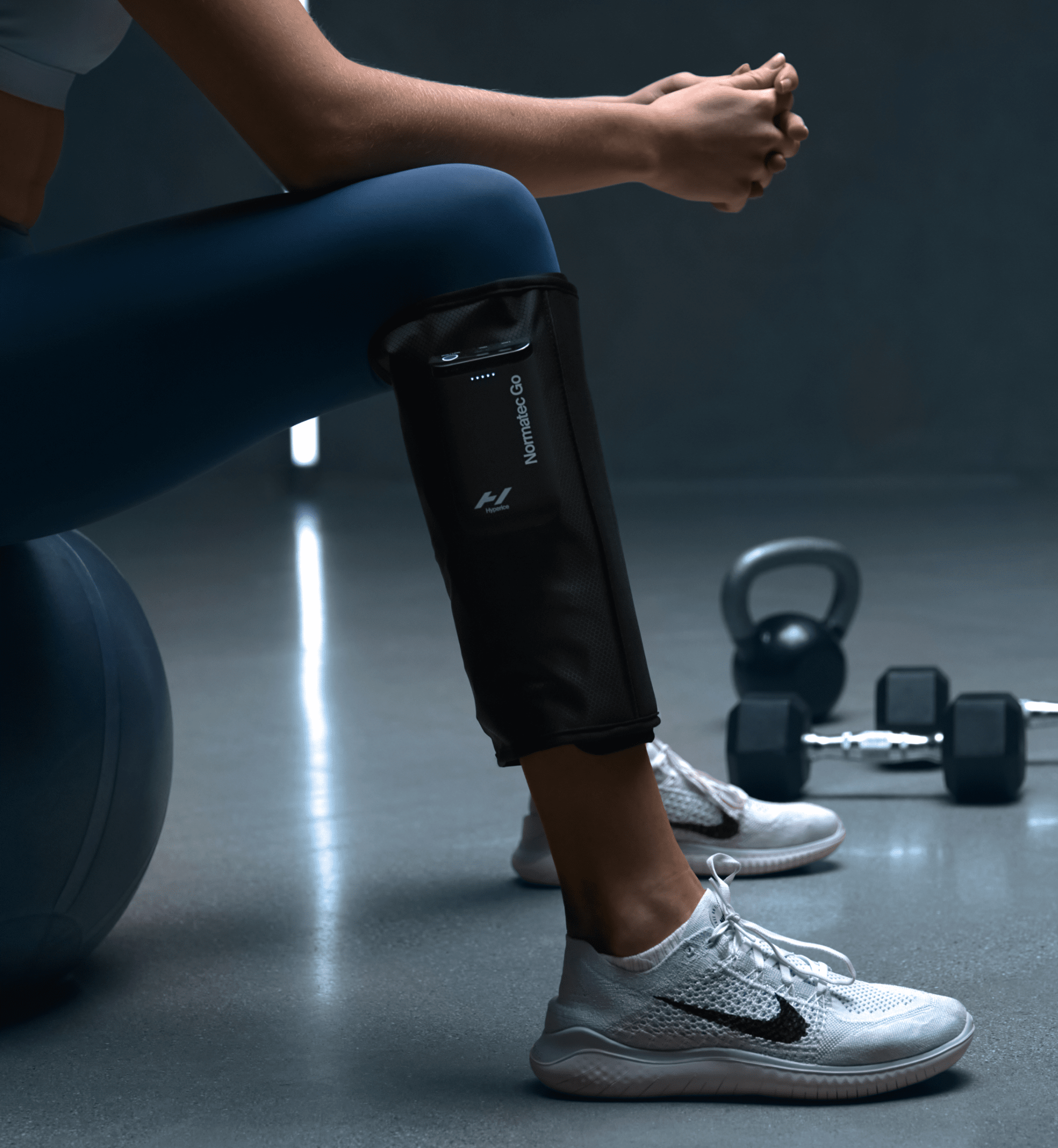 Hyperice Normatec Go portable calf compression wraps worn on both calves — view 5