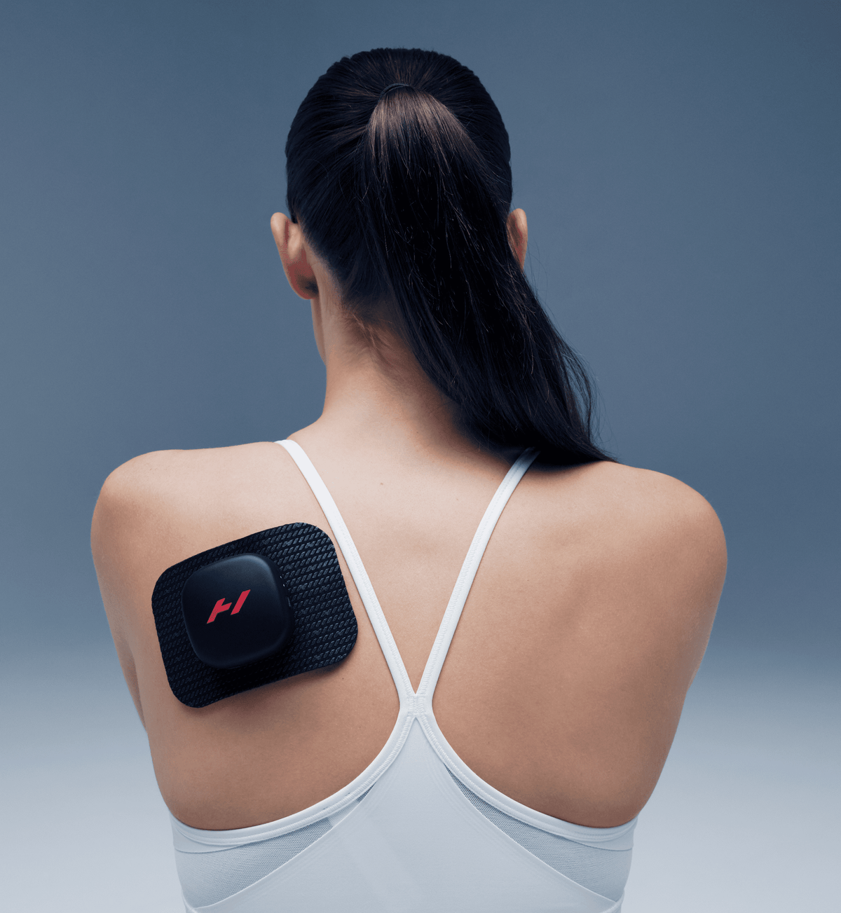 Hyperice Venom Go portable heat vibration device wrapped around a hand and thumb — view 3