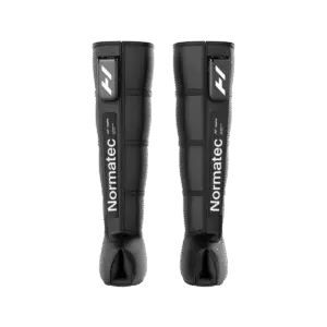Hyperice Normatec Elite leg compression boots worn on both legs with cordless control units attached