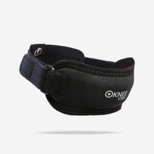 Decathlon knee support strap in smoked black, worn below the knee during a workout